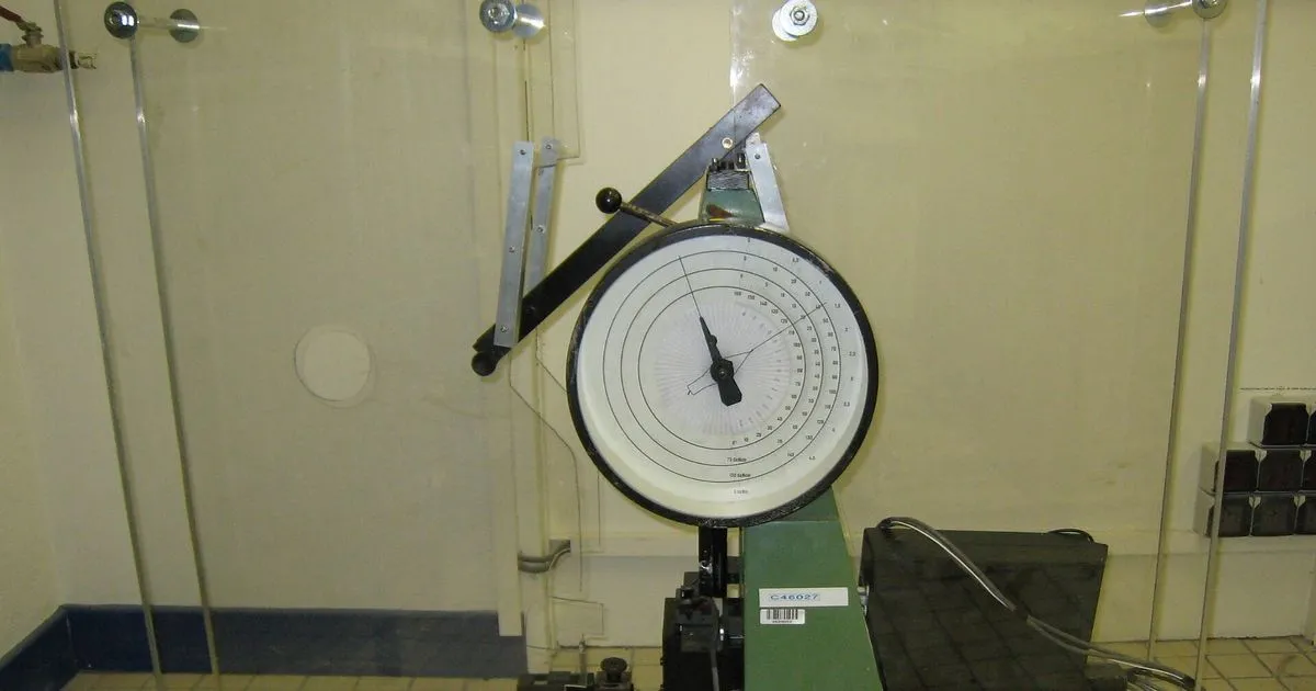 Pendulum Charpy impact tester with a dial gauge in a laboratory, used for Charpy impact steel tests at low temperature