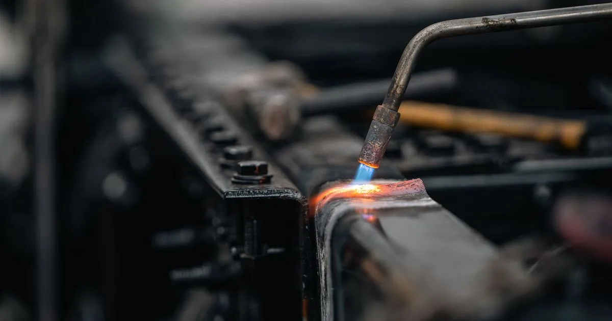 Gas torch heating the edge of a steel component to red heat, an example of preheat on thick steel before welding