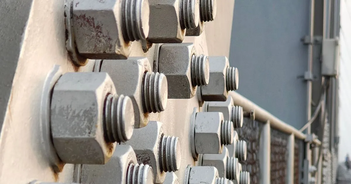Large hex head structural bolts and nuts on a bolted steel plate connection, the type of joint where A325 vs A490 bolts are chosen