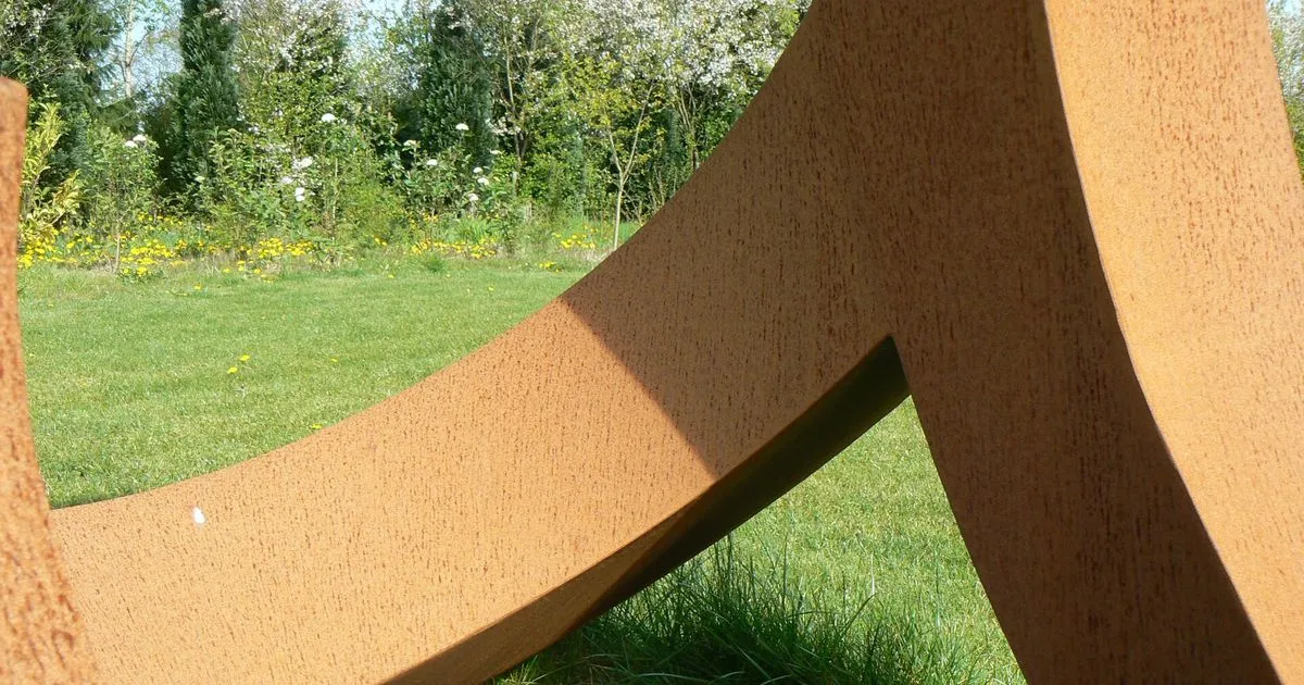 Cor-Ten weathering steel sculpture with a rust-brown patina outdoors, reference image for weathering steel fabrication